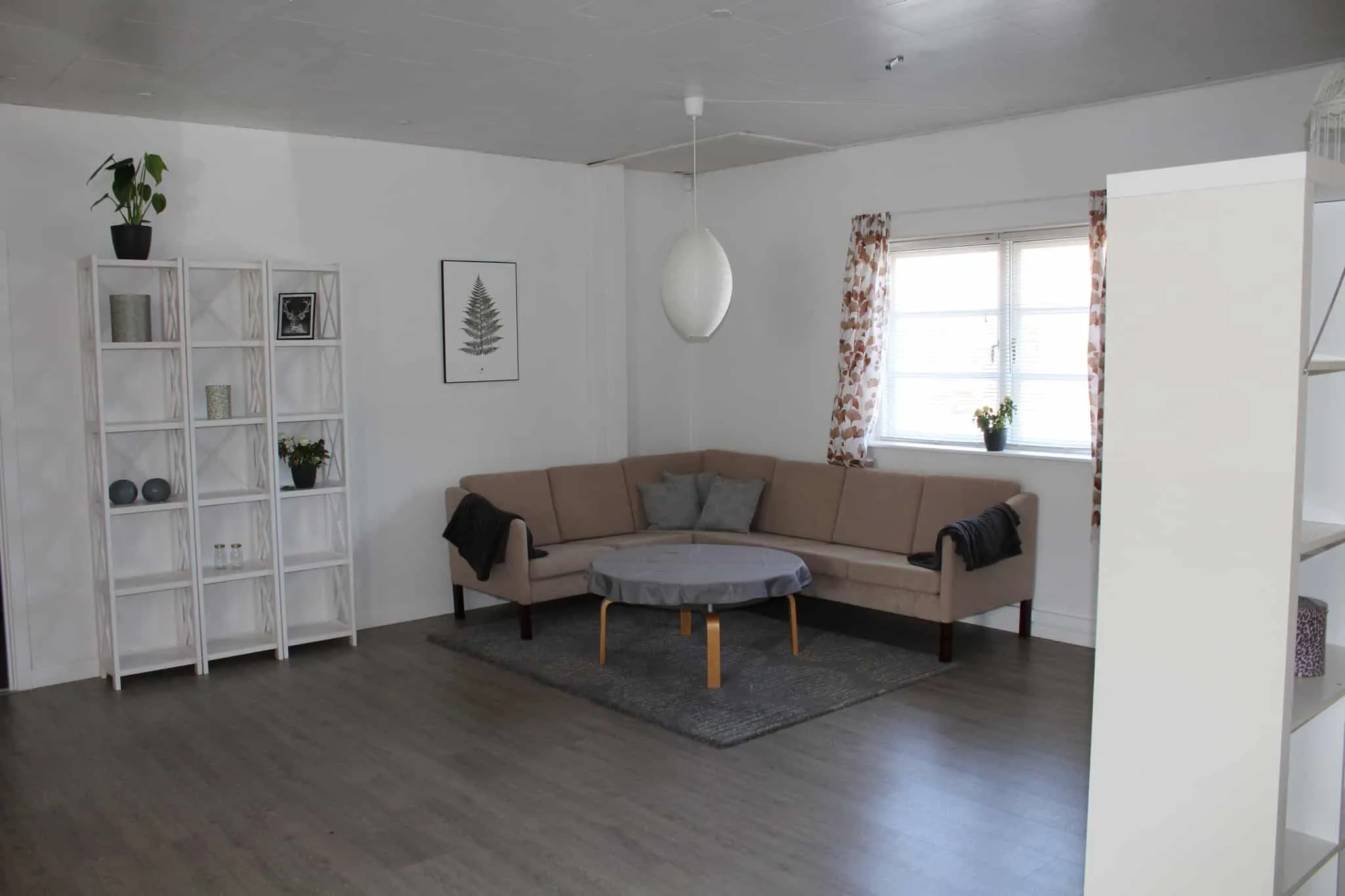 Sofakrog i fællesrummet med hjørnesofa ved vinduet